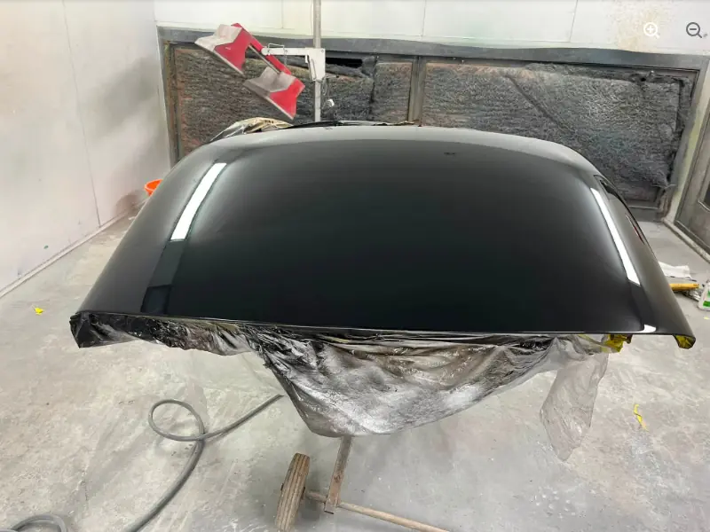A car hard top freshly painted gloss black in RPM Autocare's spray booth